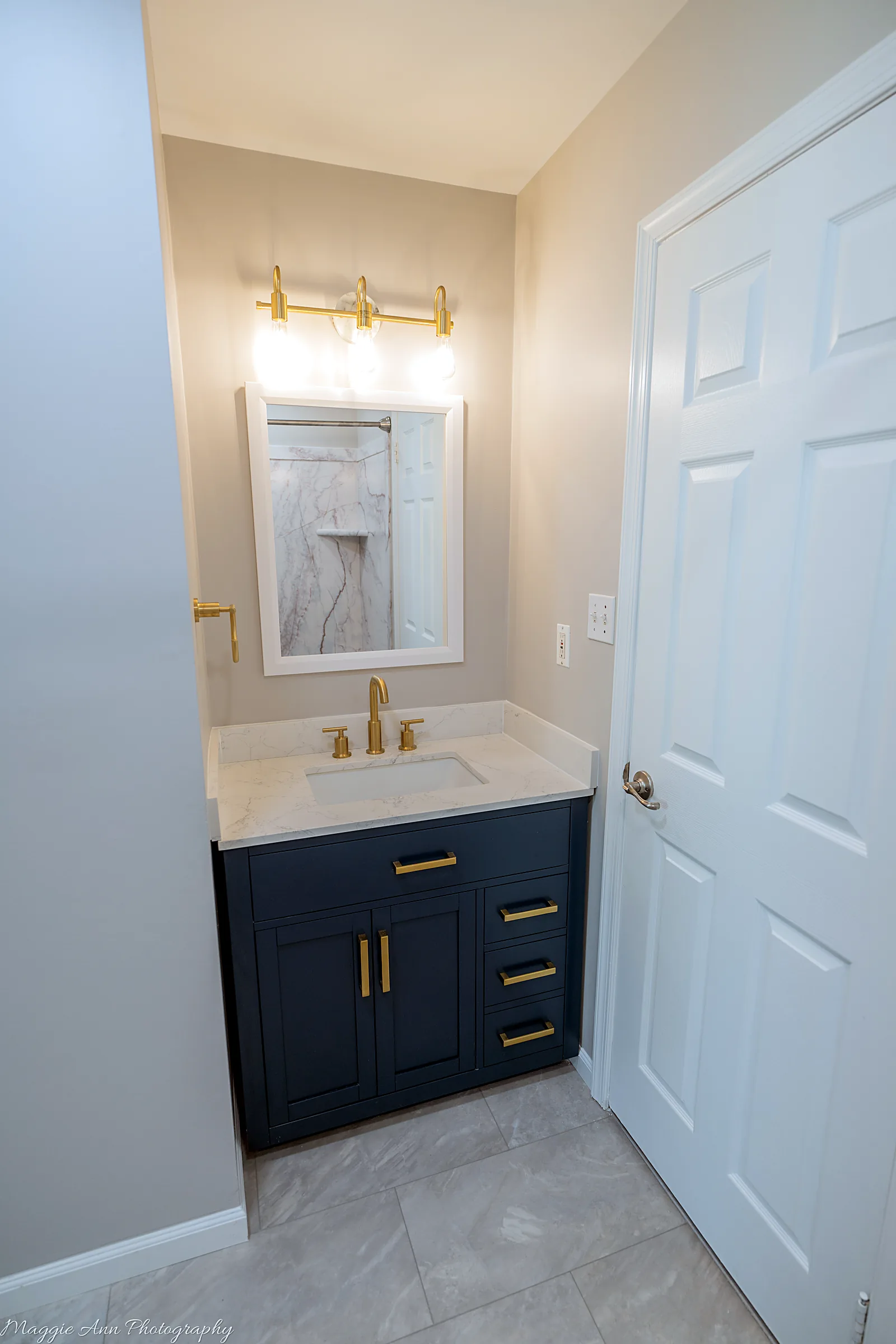 Bathroom reno: marble tub & navy vanity after